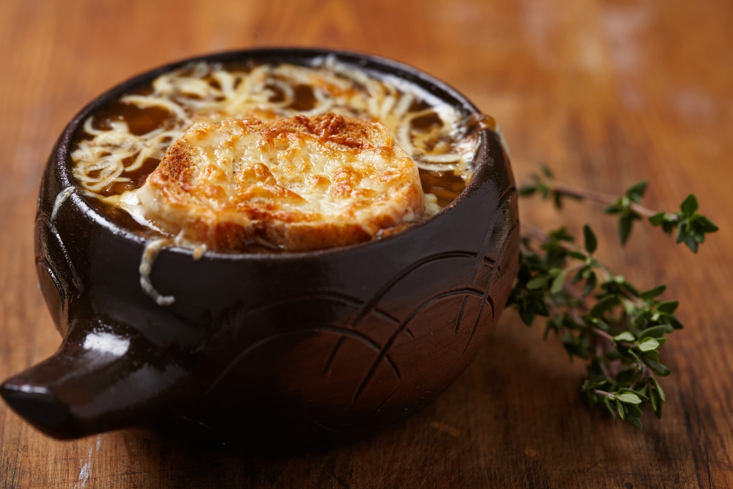 French Onion Soup in a black bowl