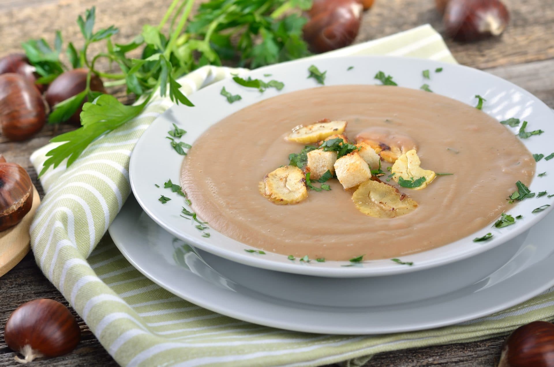 bowl of soup with croutons on a festive decorated table