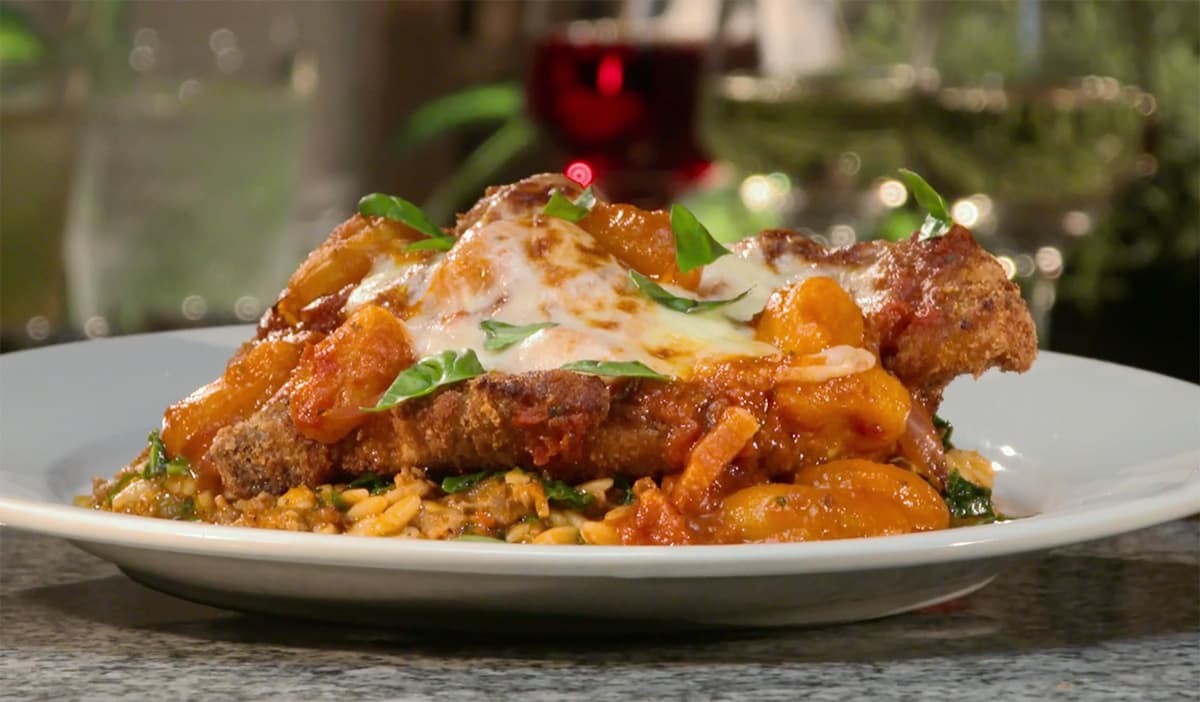 a plate of pork parmesan