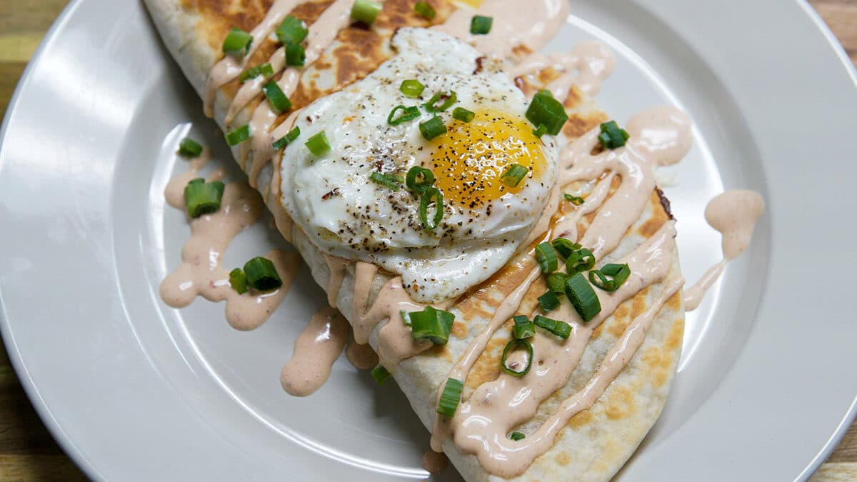 Photo of a delicious corned beef quesadilla with an egg on top